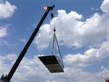 Multizone adapter curb being lifted into place